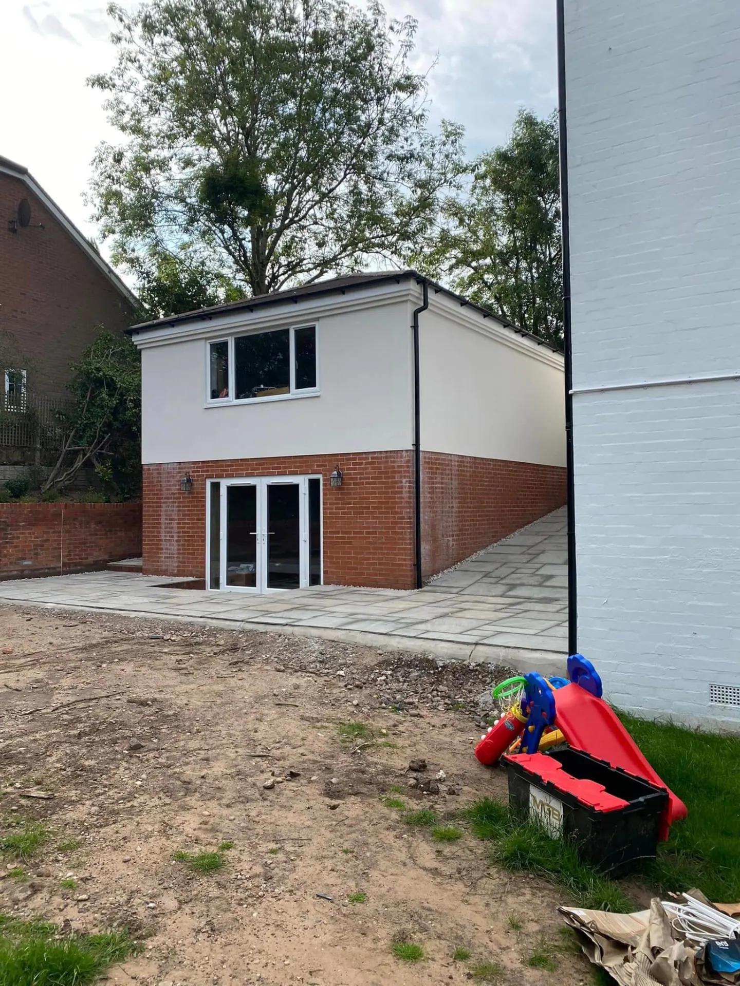 Two-storey rendered annexe with brick plinth built by JRC Developers, builders in Cofton Hackett, Worcestershire