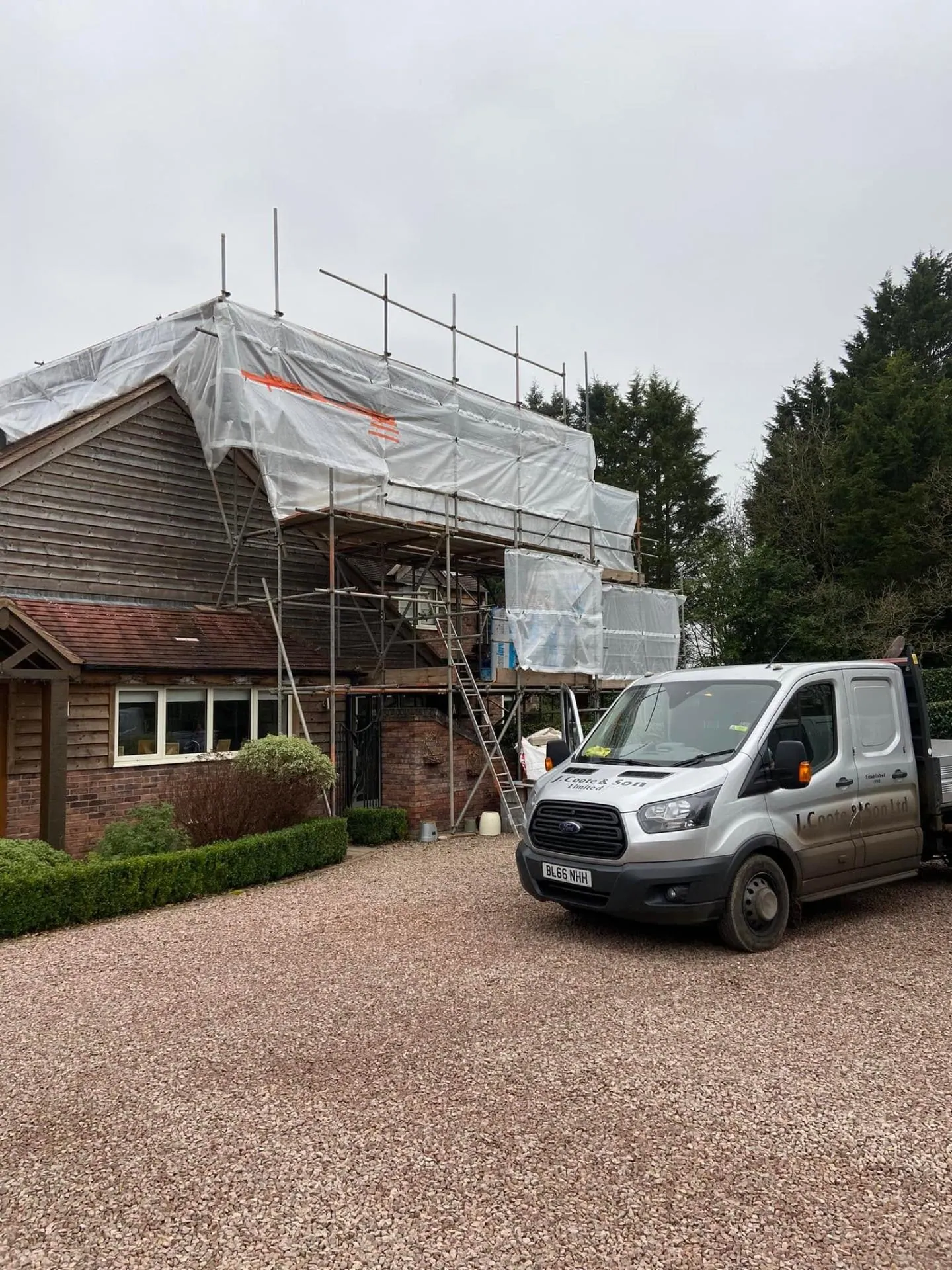 Close-up of the shrink-wrap scaffold tent over the future oak-clad gable at Dingleside, with the existing timber-clad gable of the original house visible below, JRC Developers