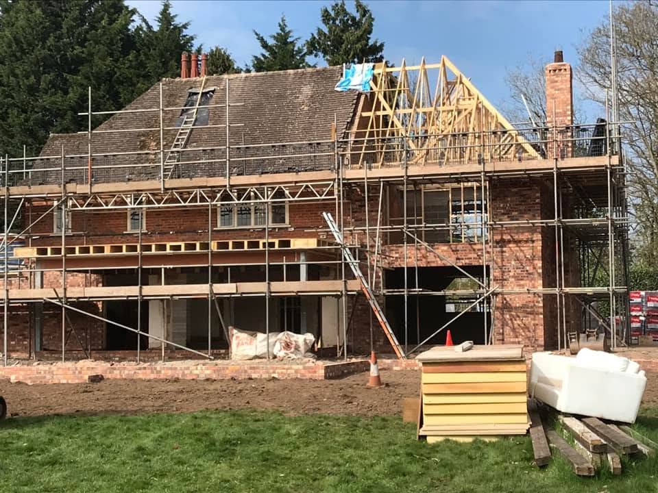 Full scaffold around the rear of the house with new roof trusses being formed as part of the large remodelling project