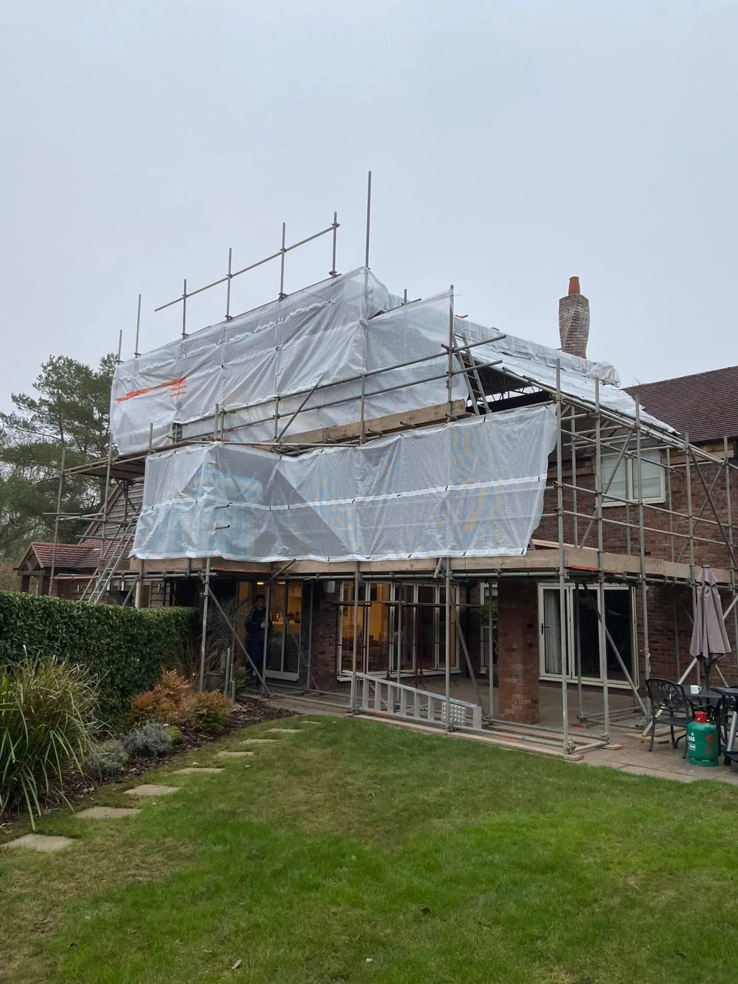 Full-height scaffold wrap over the covered terrace footprint at Dingleside, JRC Developers